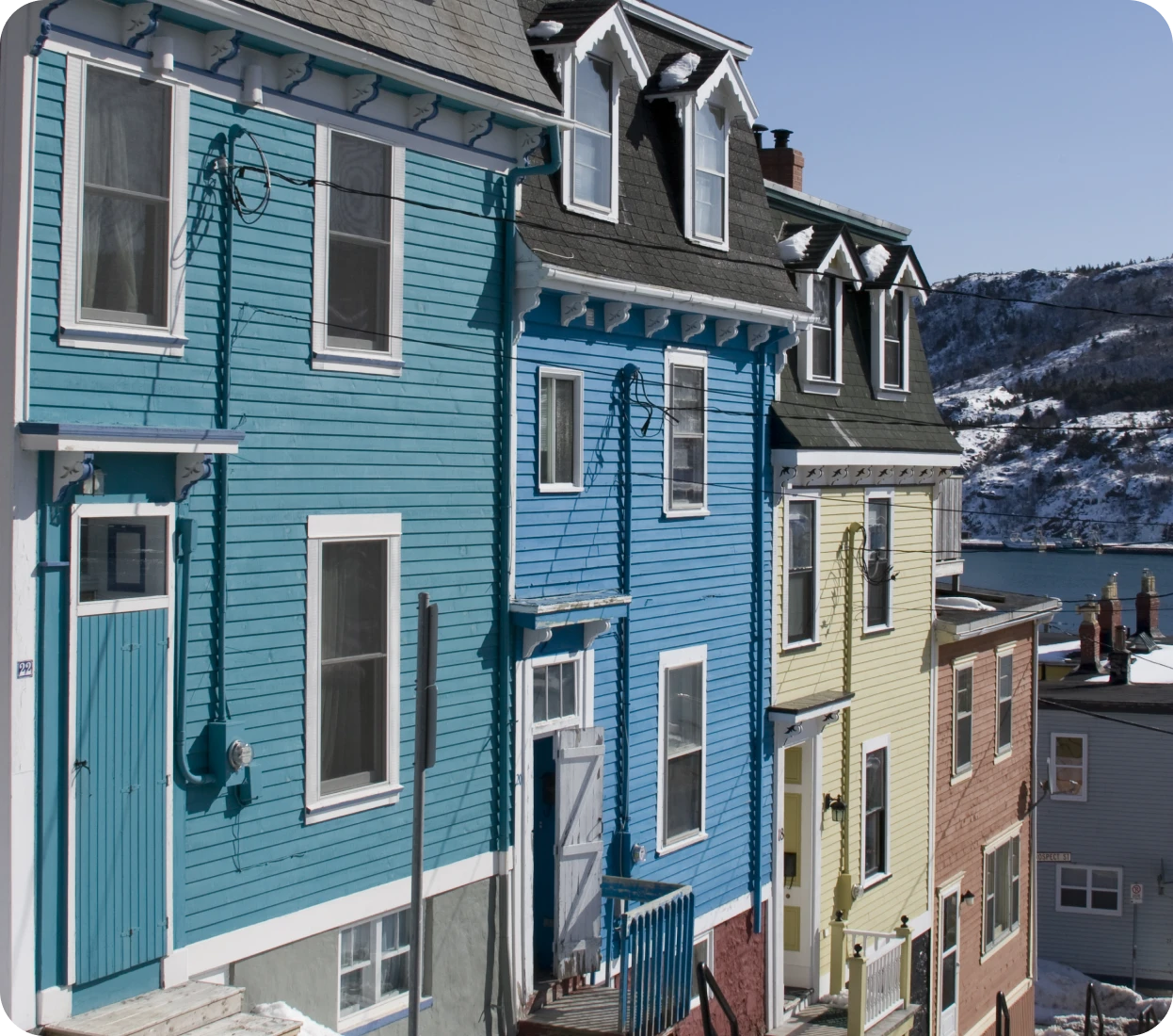Brightly painted homes in a snowy setting