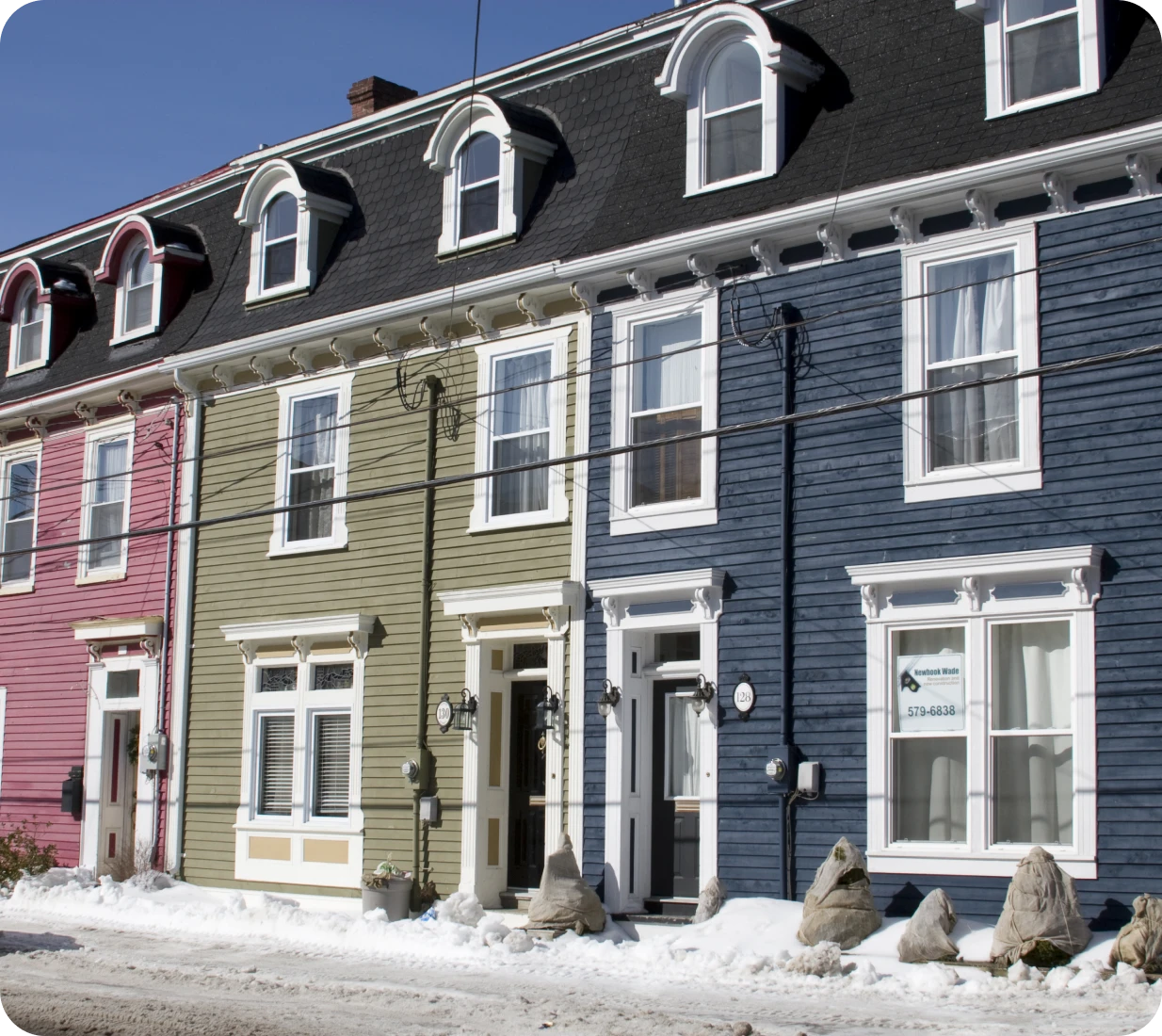 Vibrant homes with snow-covered sidewalk